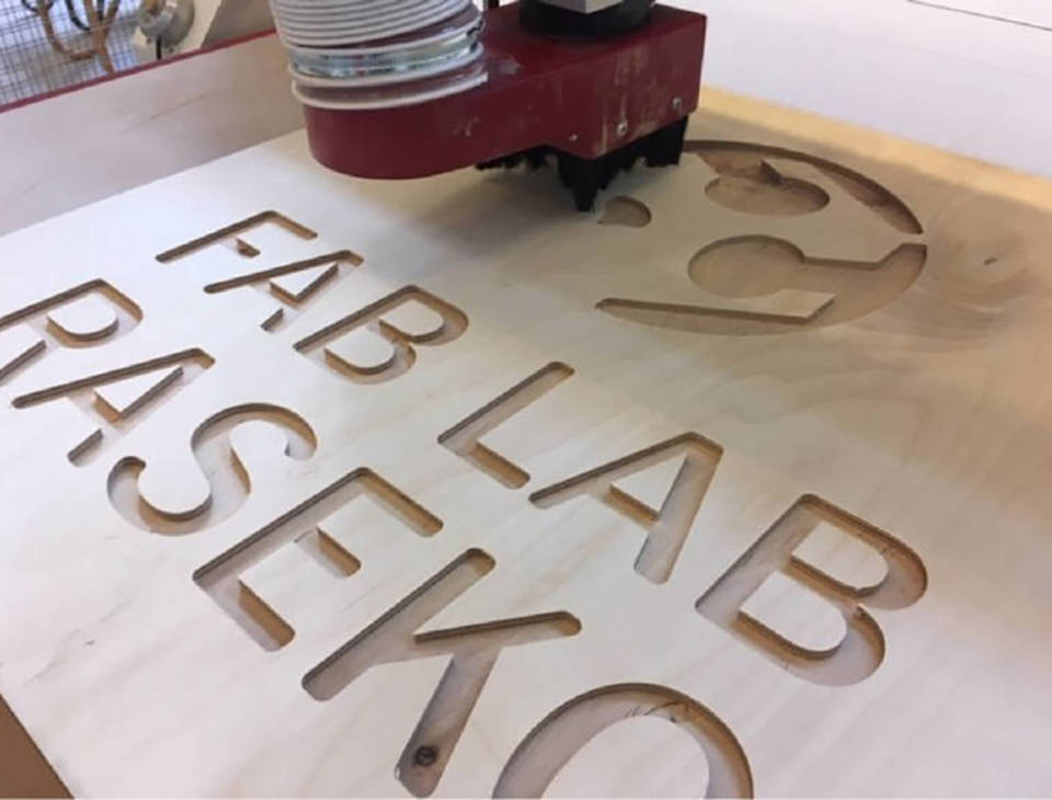 cnc-cutter mills the logo on the plywood board.