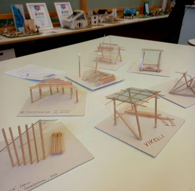 Models of a modern summerhouse on the table.